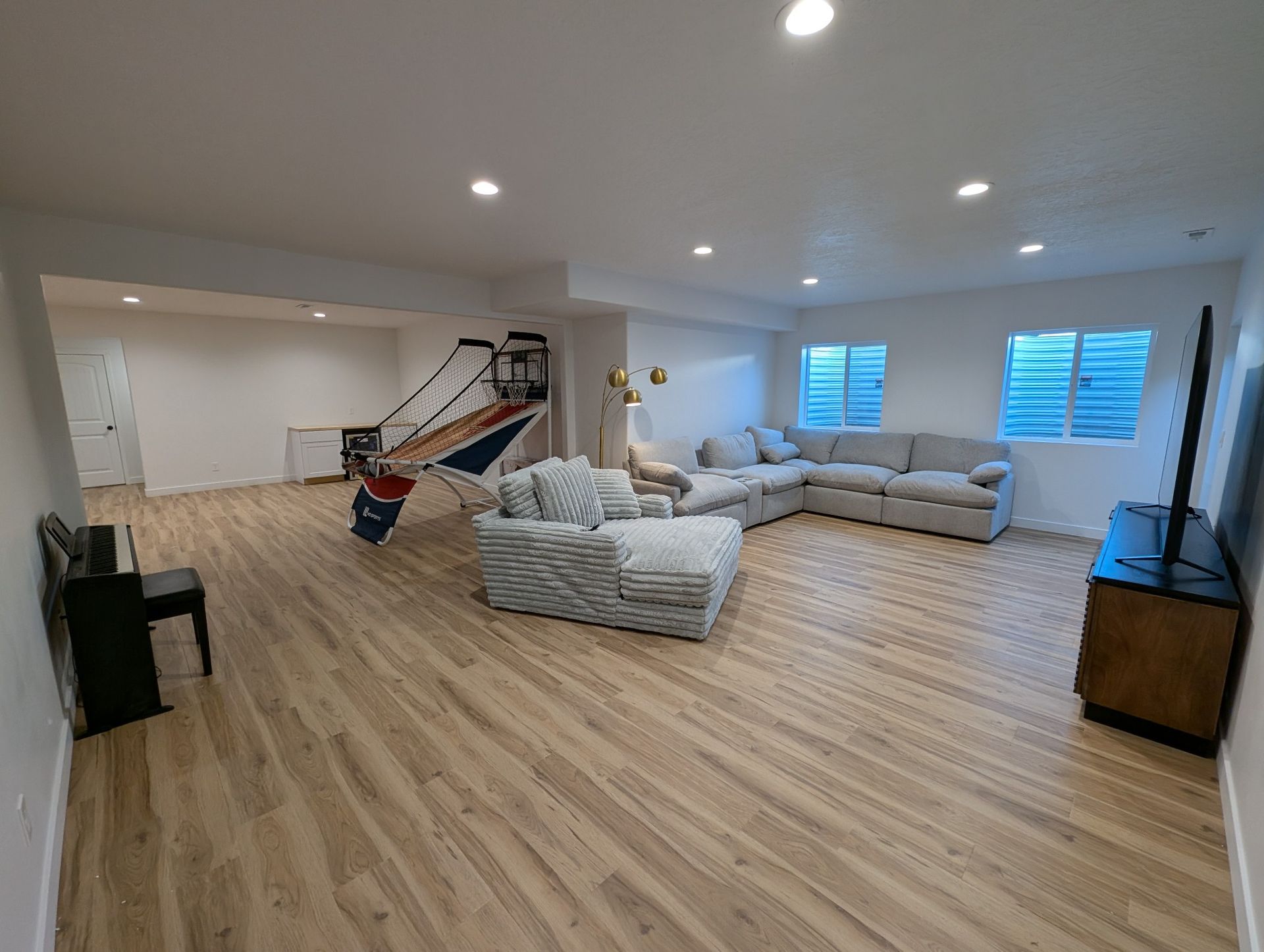 A living room with a large sectional couch and a hammock.