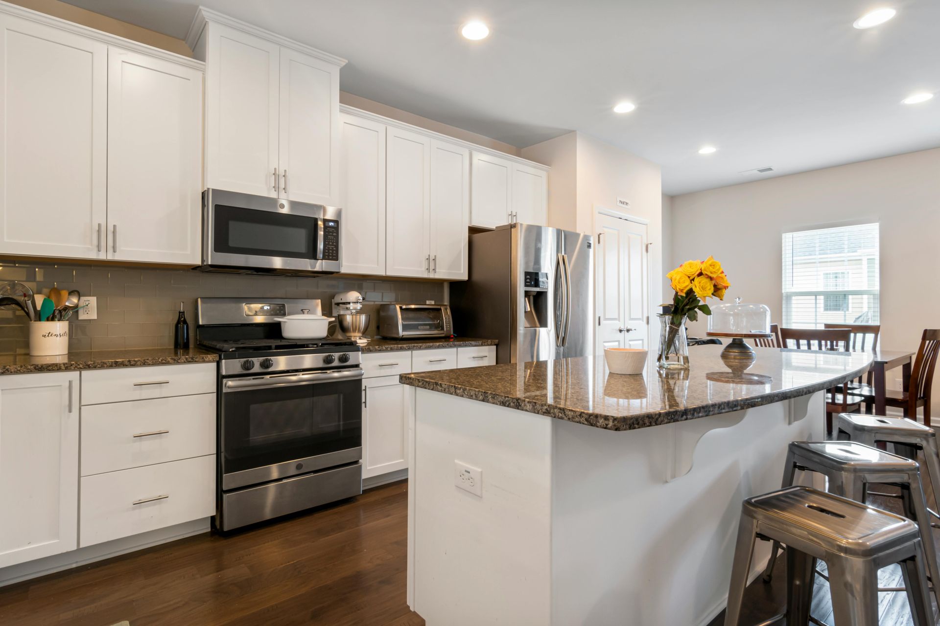 Clean-lined kitchen featuring neutral tones, natural materials, and classic finishes