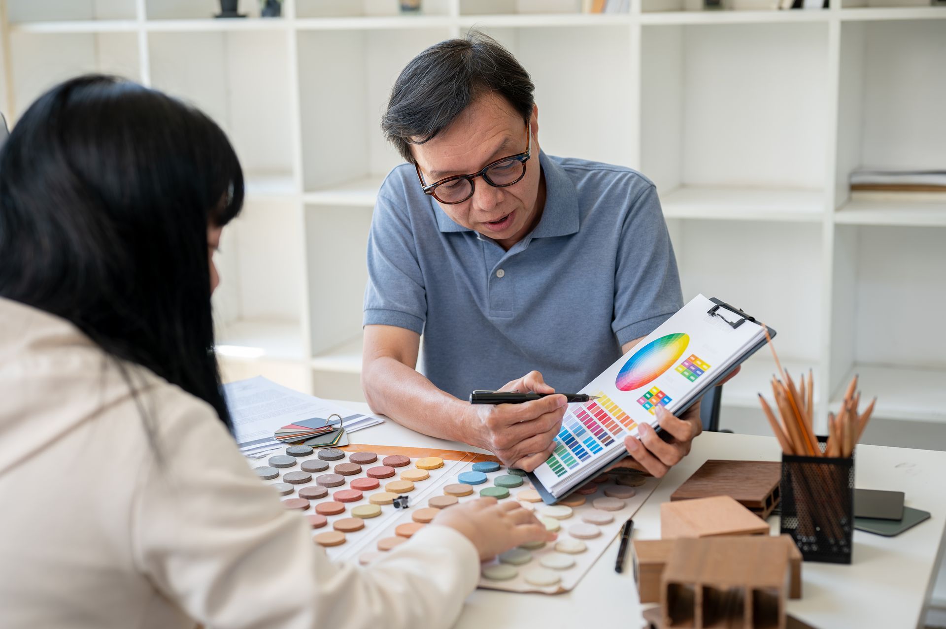 A painting contractor talks about colors with a prospective client