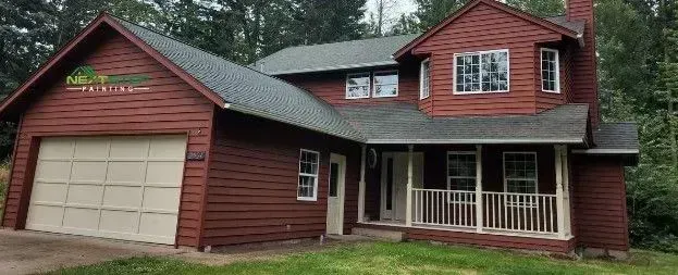 A red painted house with a garage