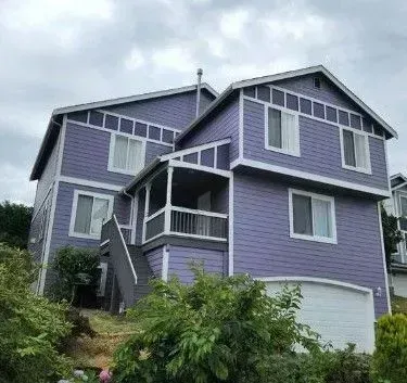Purple painted house with white garage