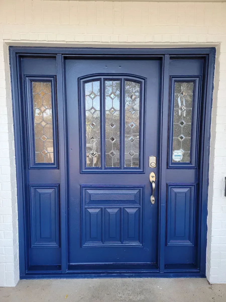 Blue painted front door with a glass window