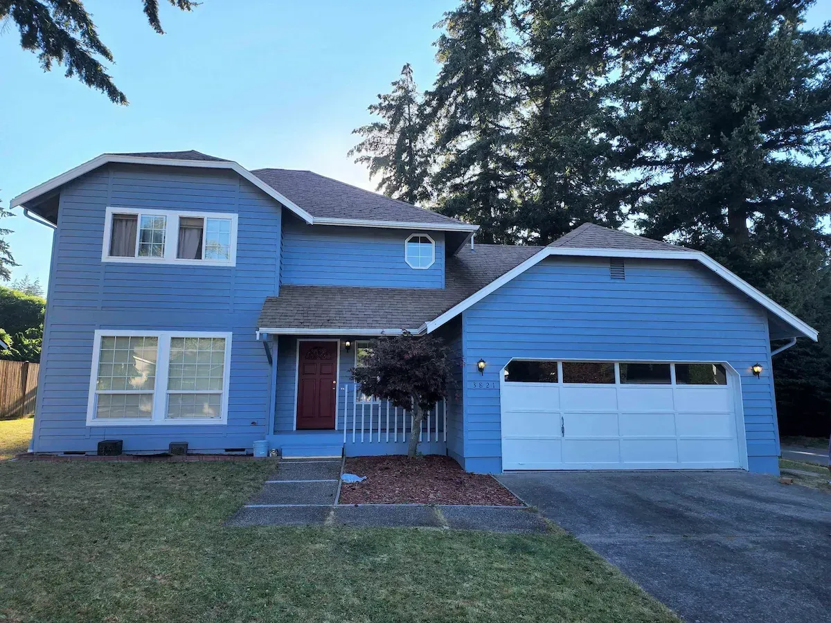 A blue house with a white garage