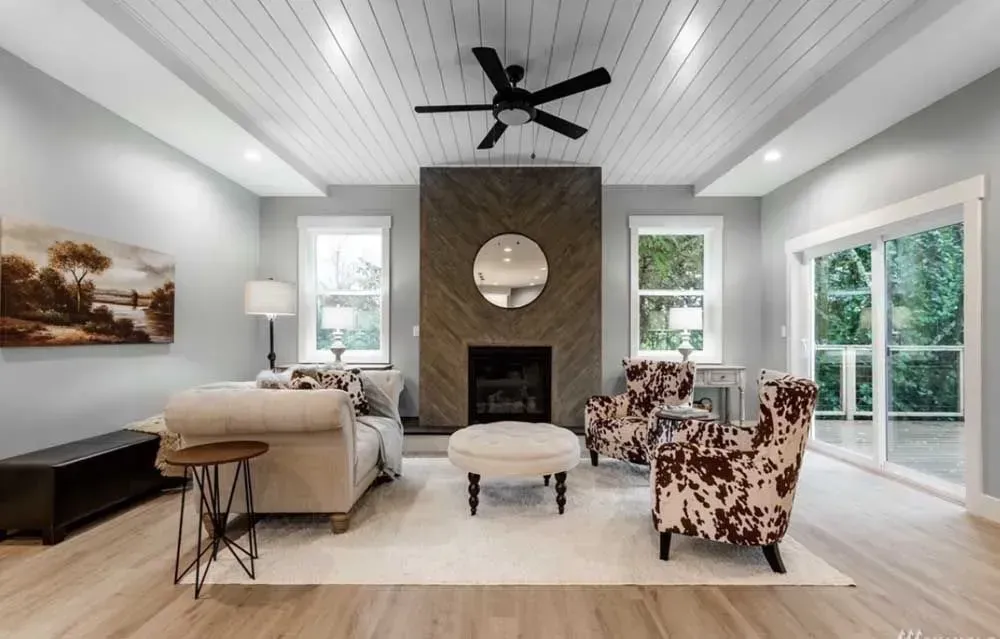 A newly painted living room with a fireplace and a couch
