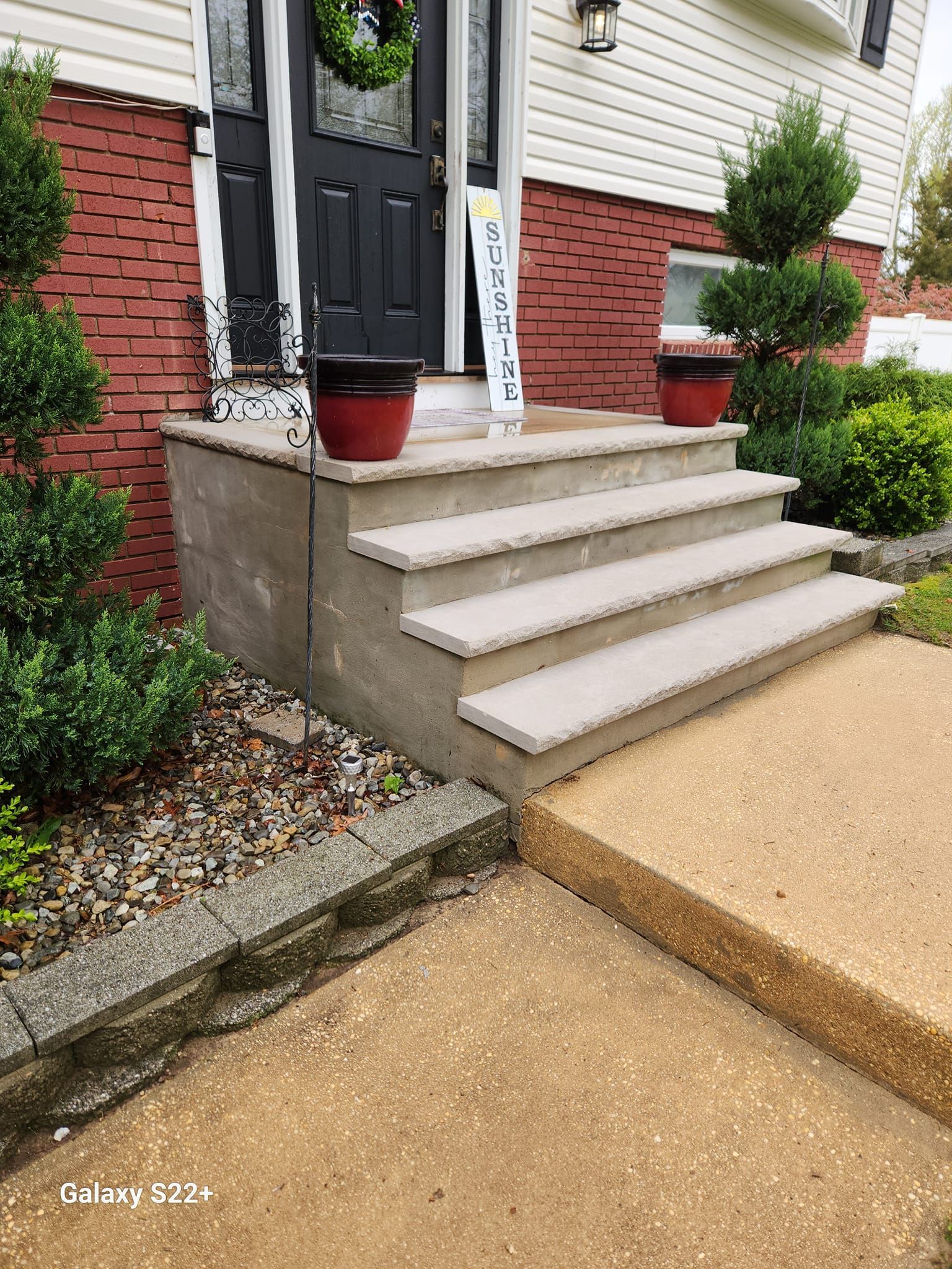 A set of stairs leading up to the front door of a house.