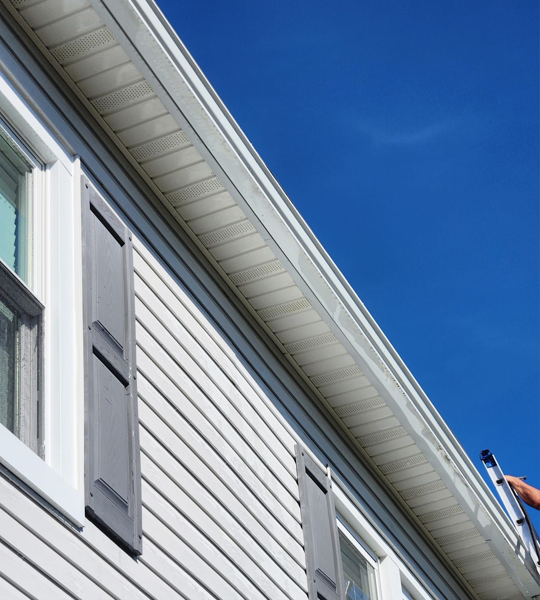 A house with a porch and a fence in the backyard.