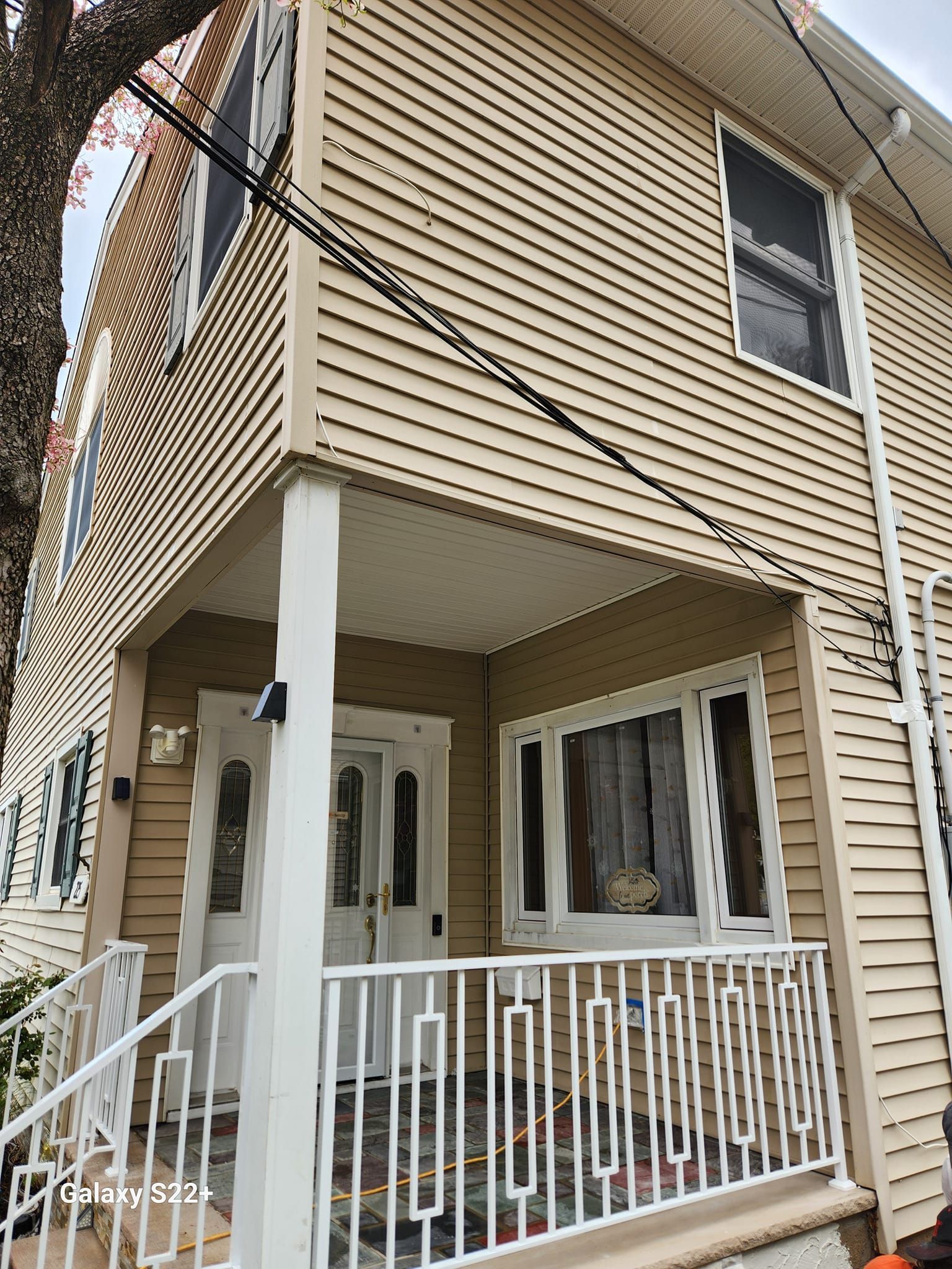 The front of a house with a porch and stairs