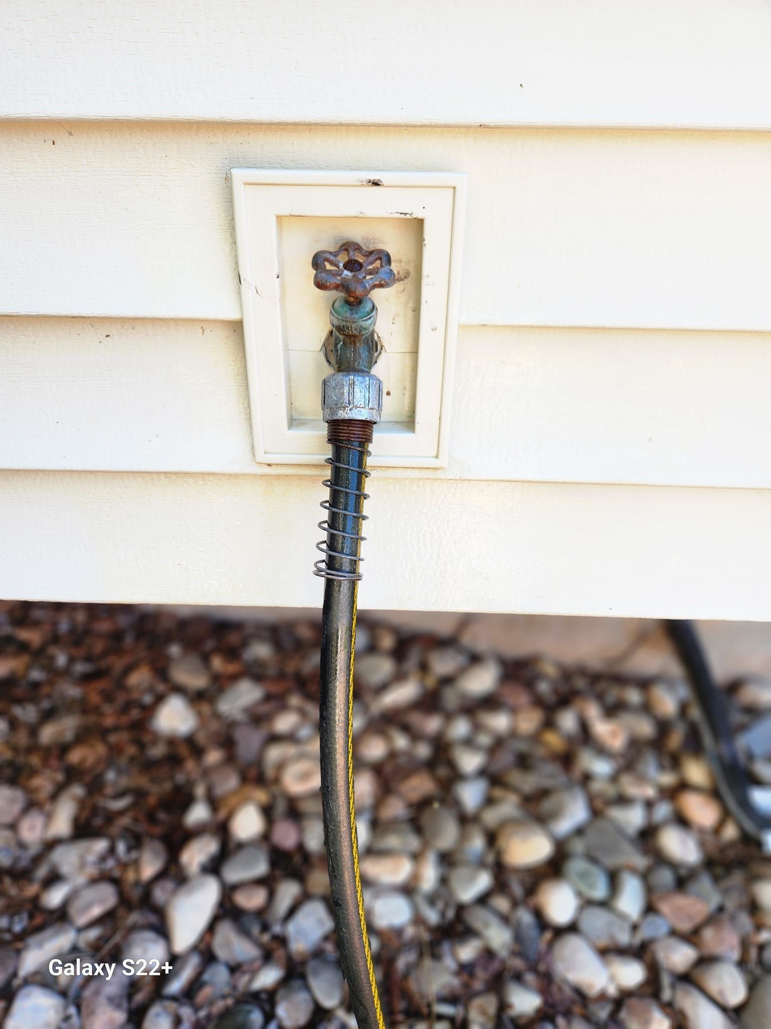 A hose is attached to the side of a house.