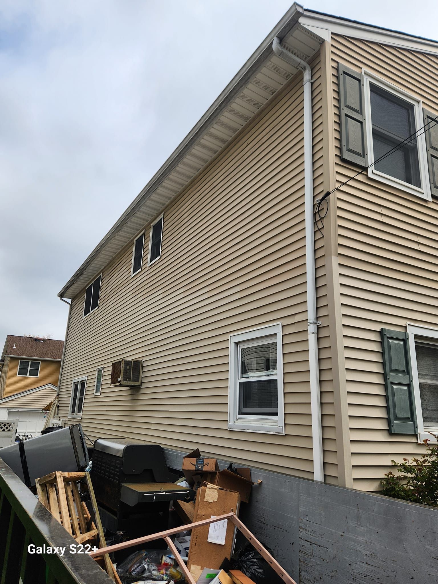 A house with a lot of trash on the side of it