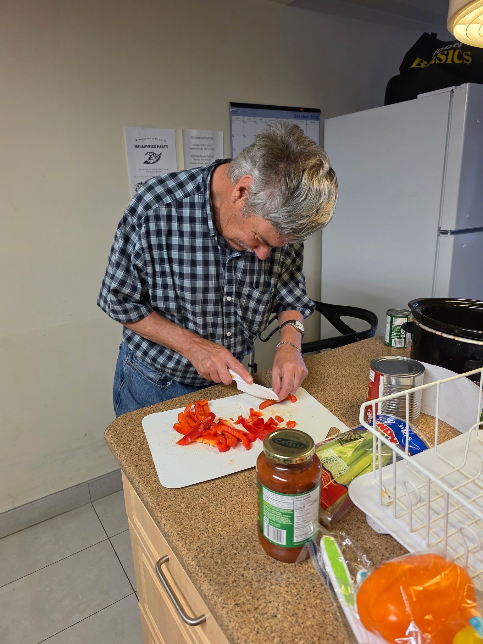 A man is stretching a person 's leg on a table.