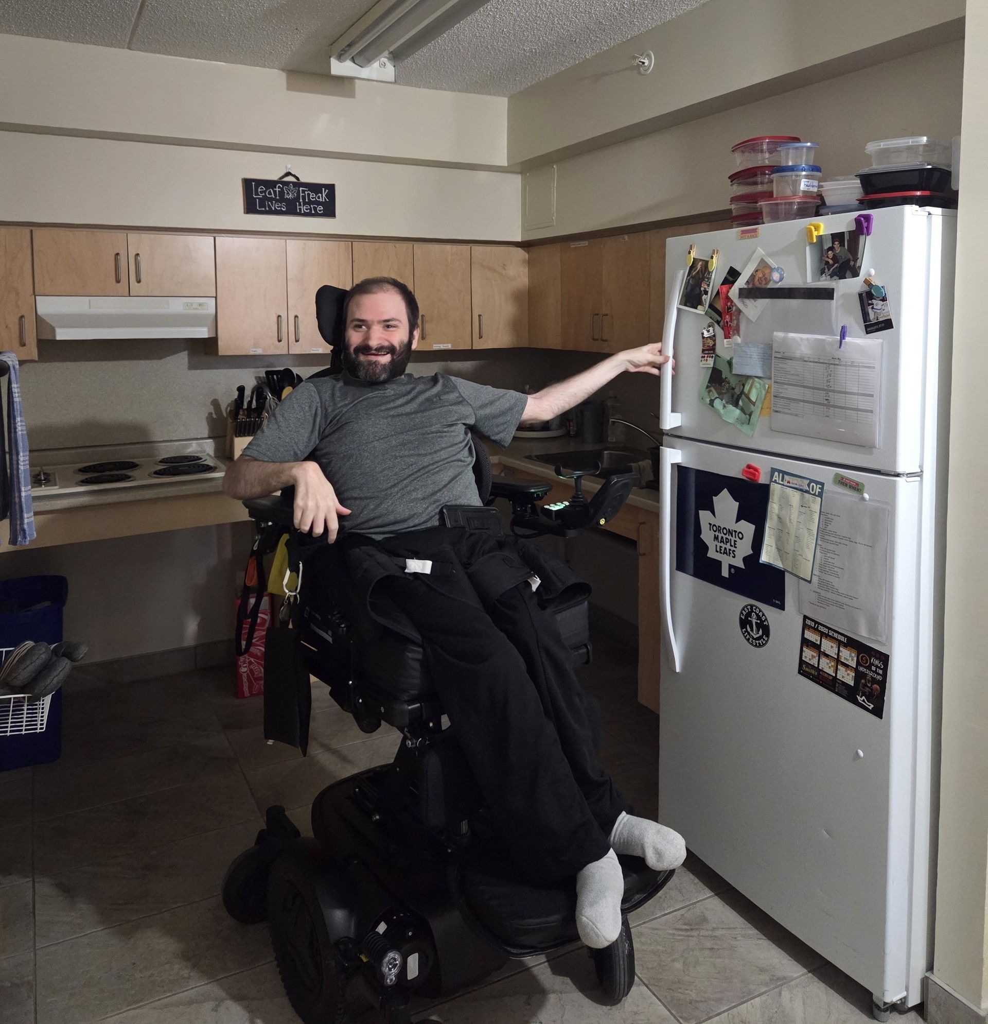 A man is walking on a treadmill with a physical therapist.