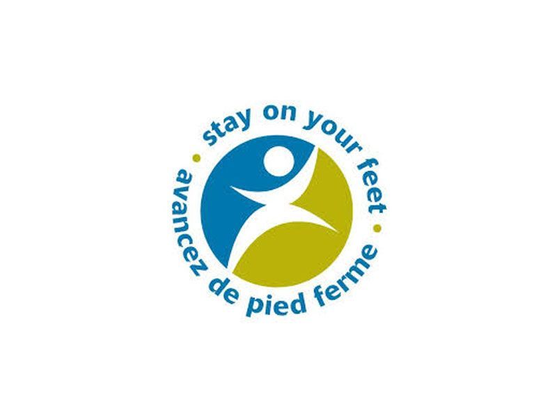 A blue and green logo that says stay on your feet