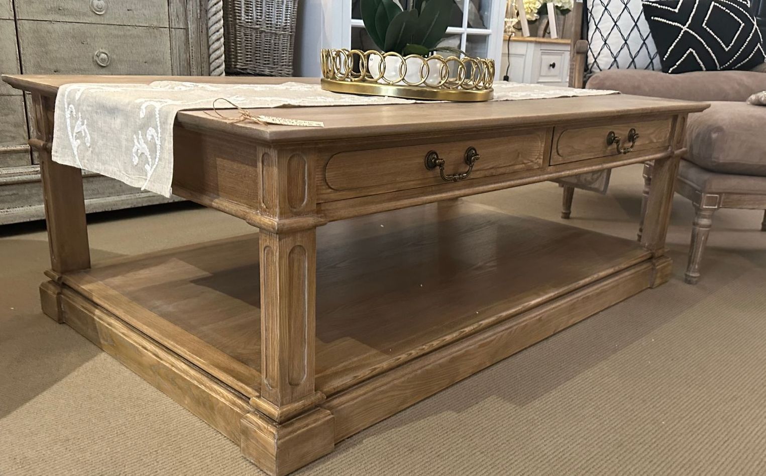 An all timber coffee table with a shelf below.