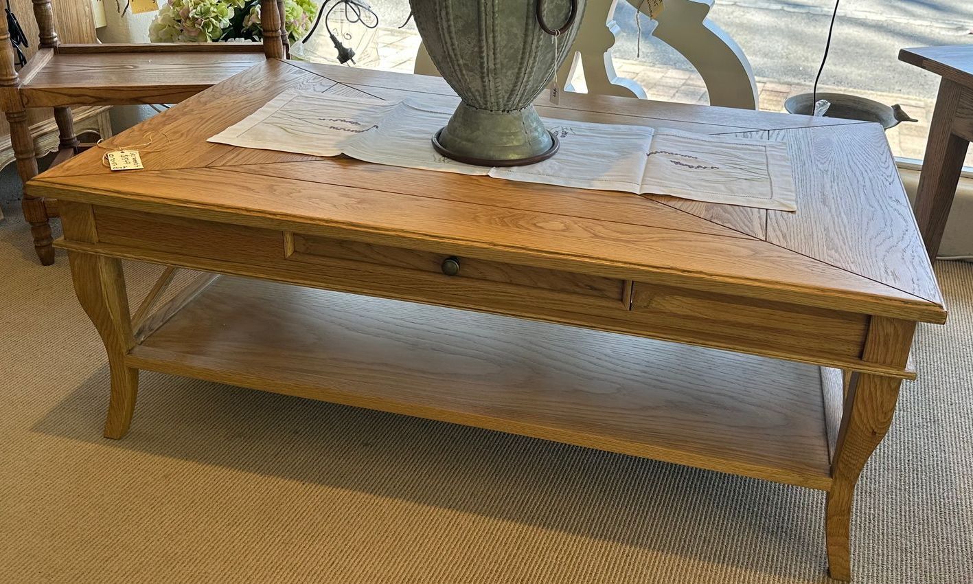 An all timber coffee table with a shelf below.
