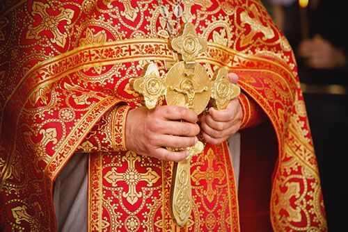 a priest holding a cross