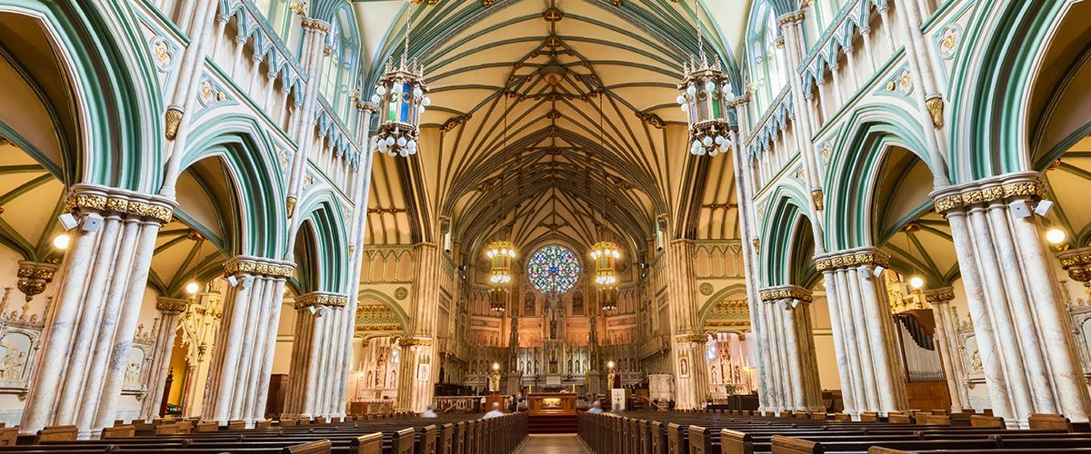 The inside of a church with a clock on the ceiling