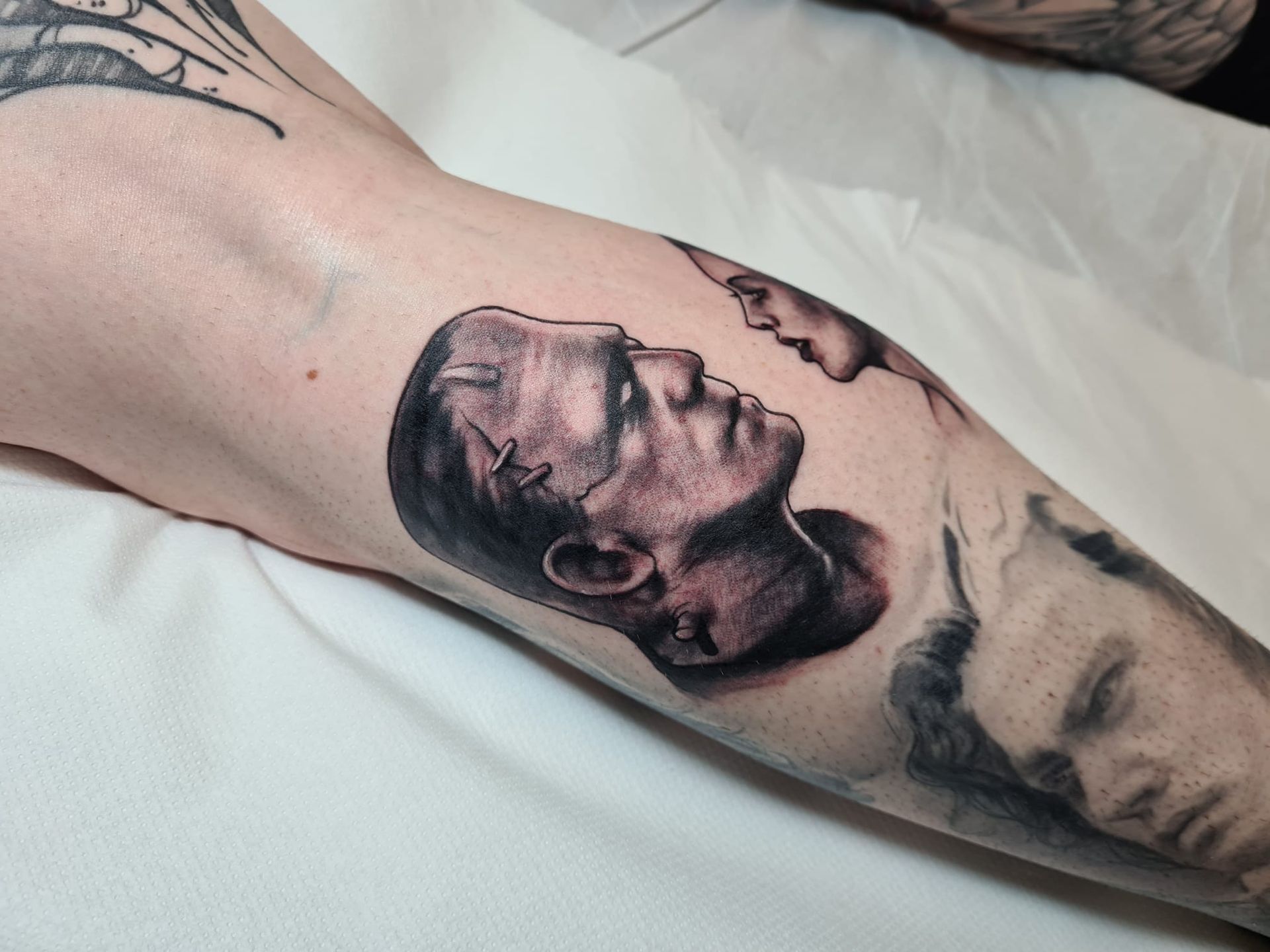 A person has a tattoo of frankenstein on their arm
