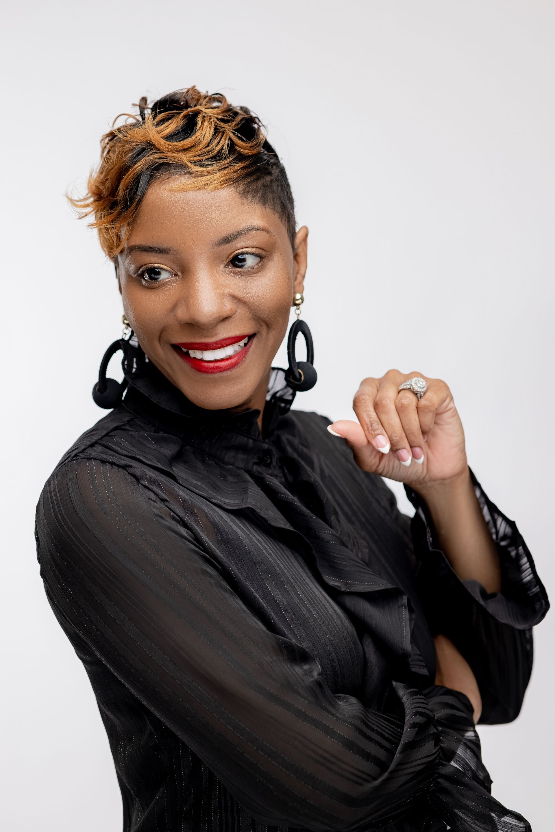 A living room with a couch and a wooden table with a vase of flowers on it.