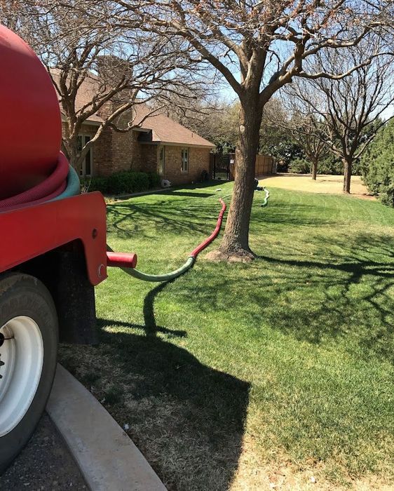 A Red Truck with a Hose Attached — Lubbock, TX — Berryhill Sewer Inc.