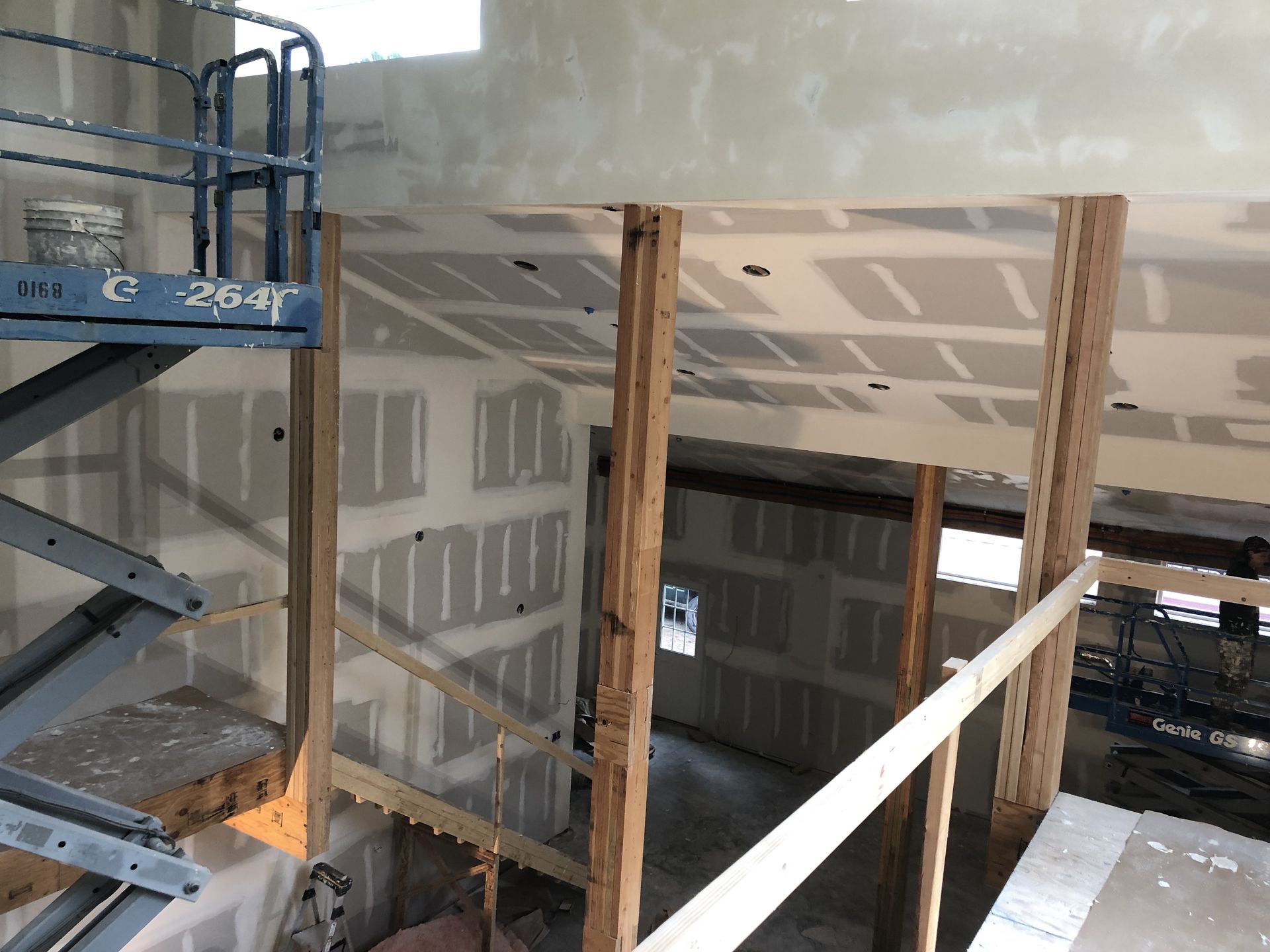 A construction site with a ladder and a bucket on it