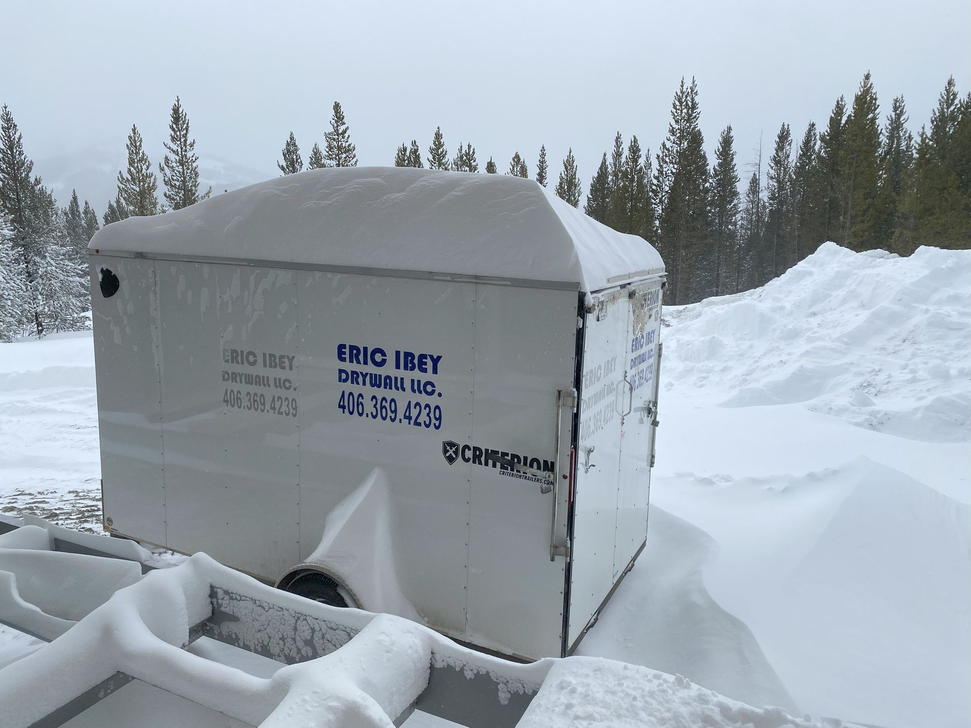 a trailer is covered in snow and says eric reef on it