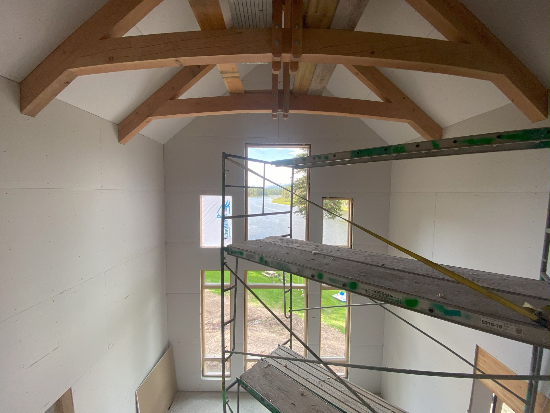 a room with a lot of windows and scaffolding in it .