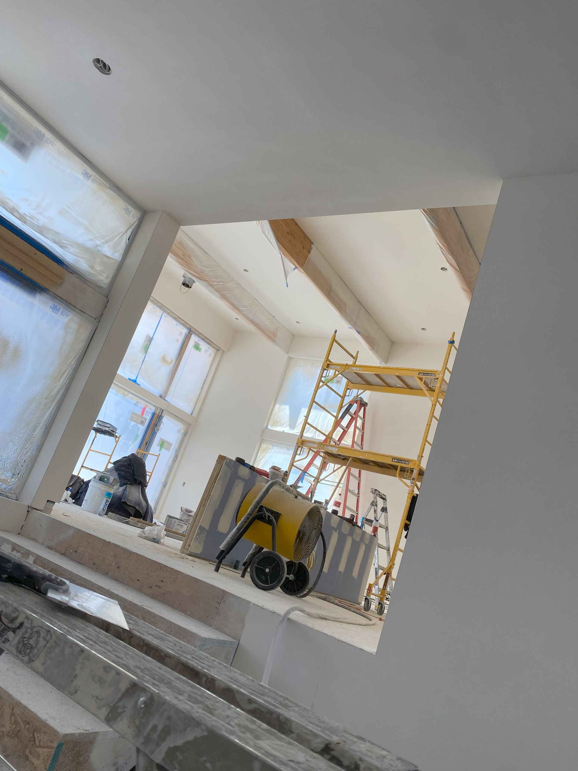 a truck is parked in front of a row of houses under construction .