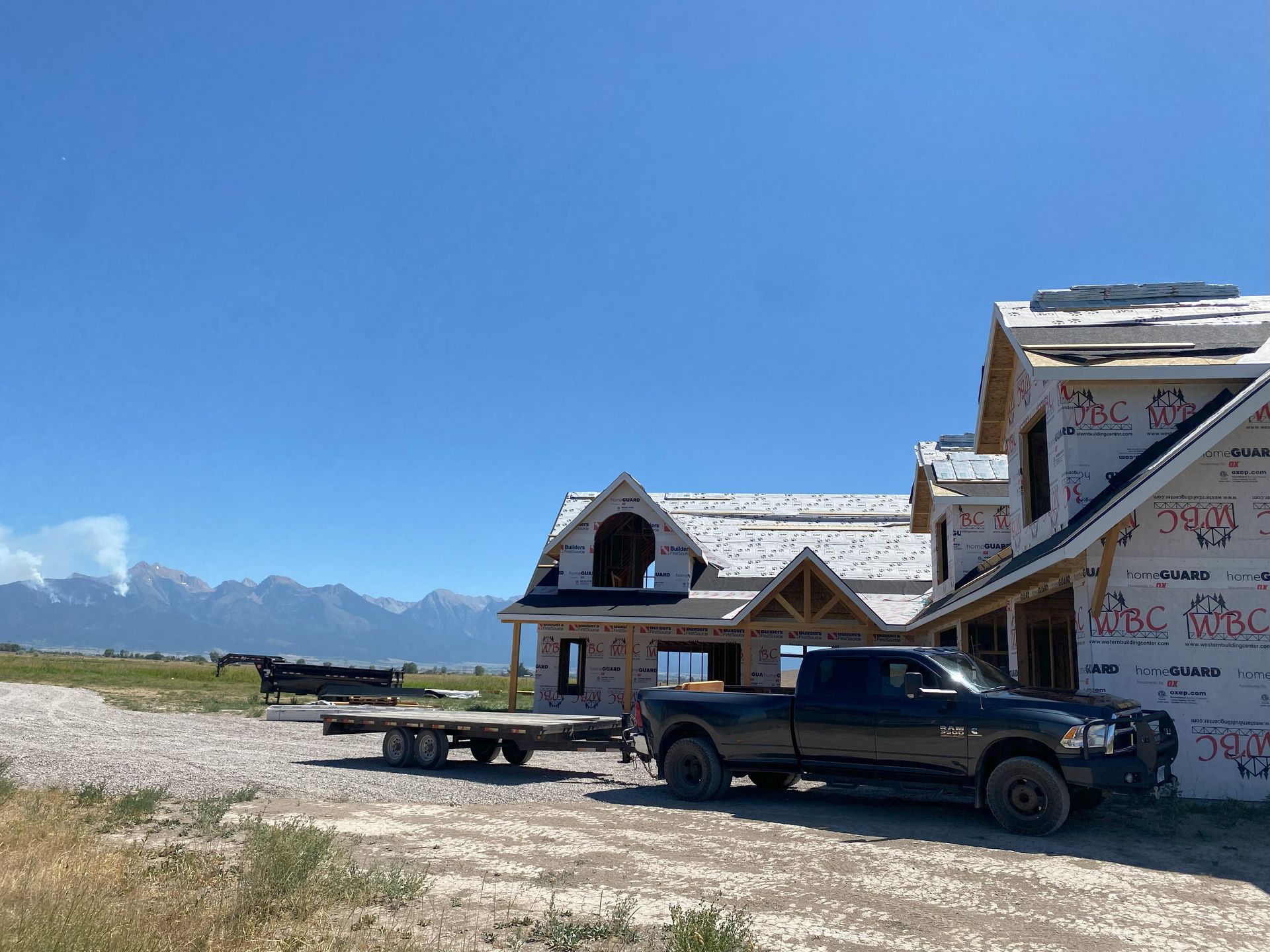 a truck is parked in front of a house under construction .