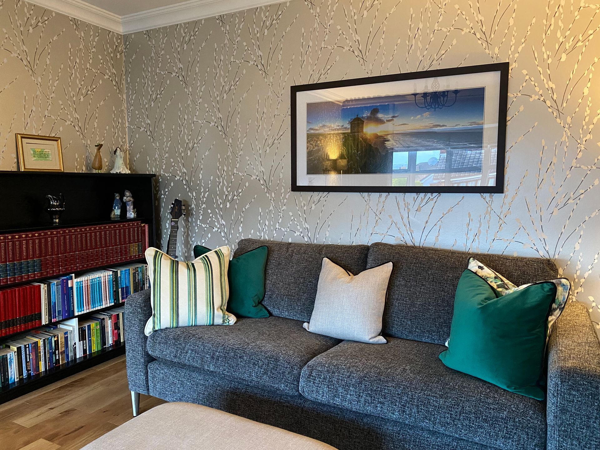 A living room with a couch and a picture on the wall above it