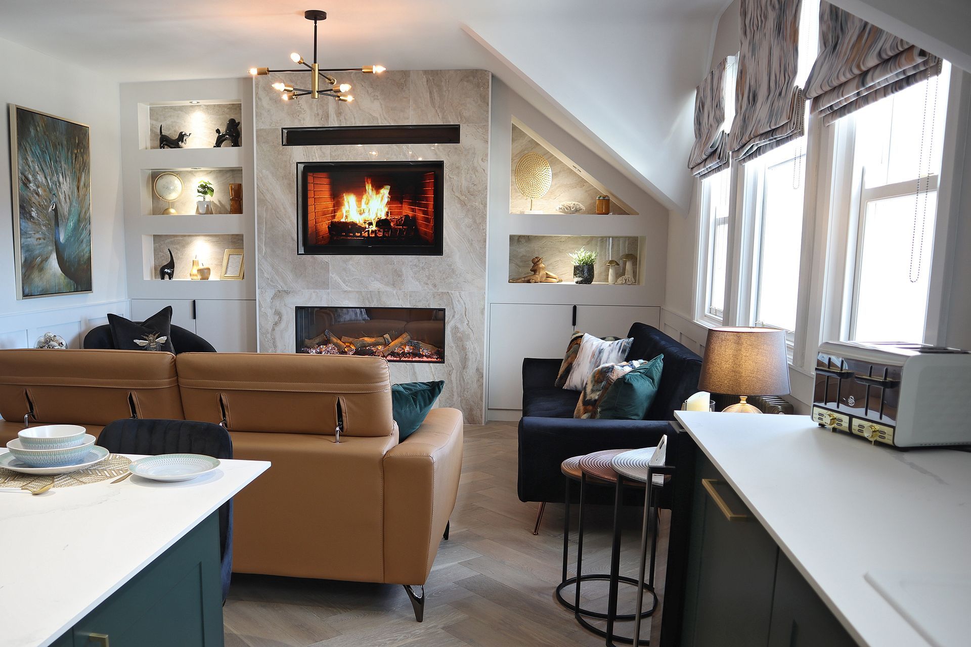 A living room with a couch , fireplace and television.