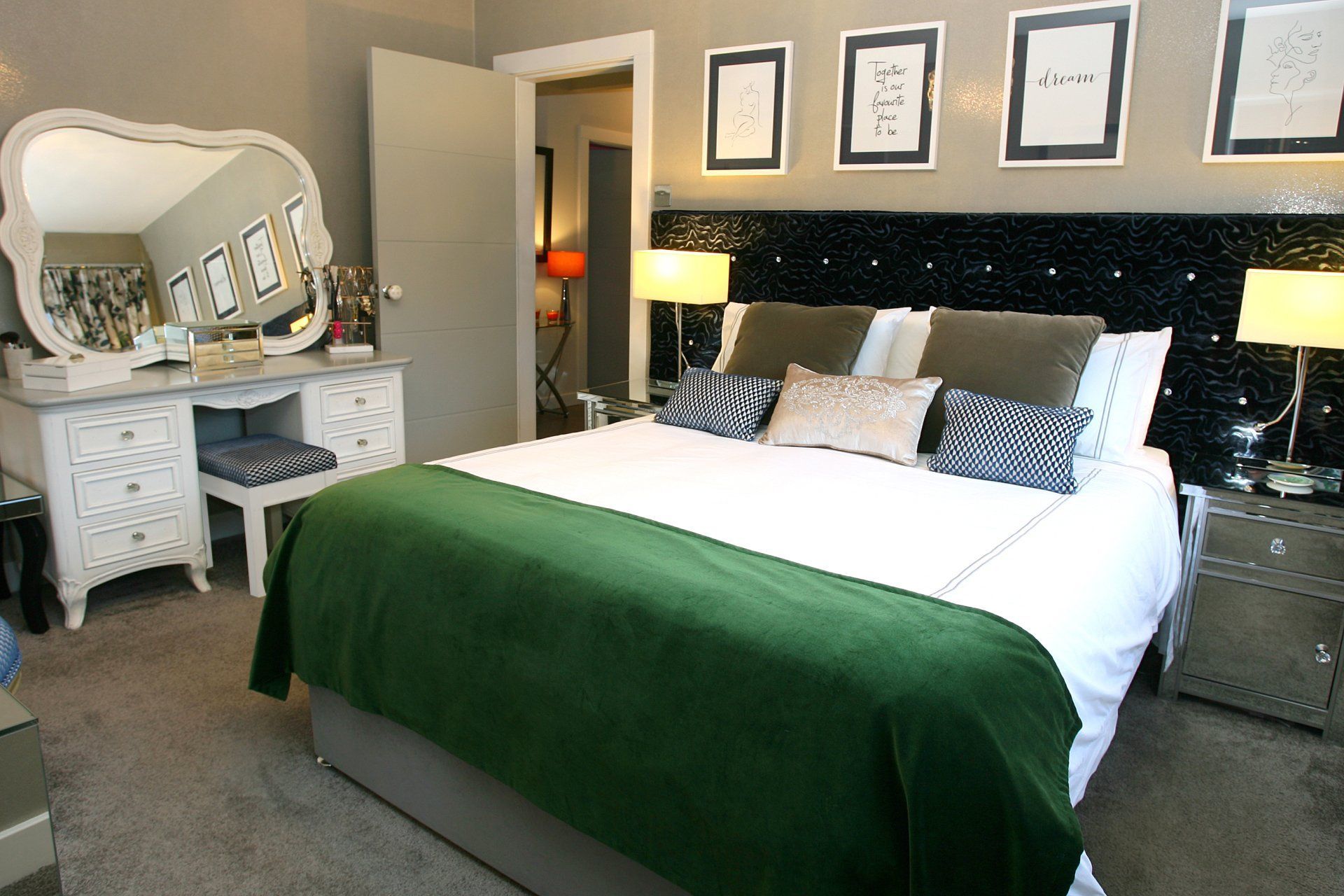 A bedroom with a large bed and a mirror
