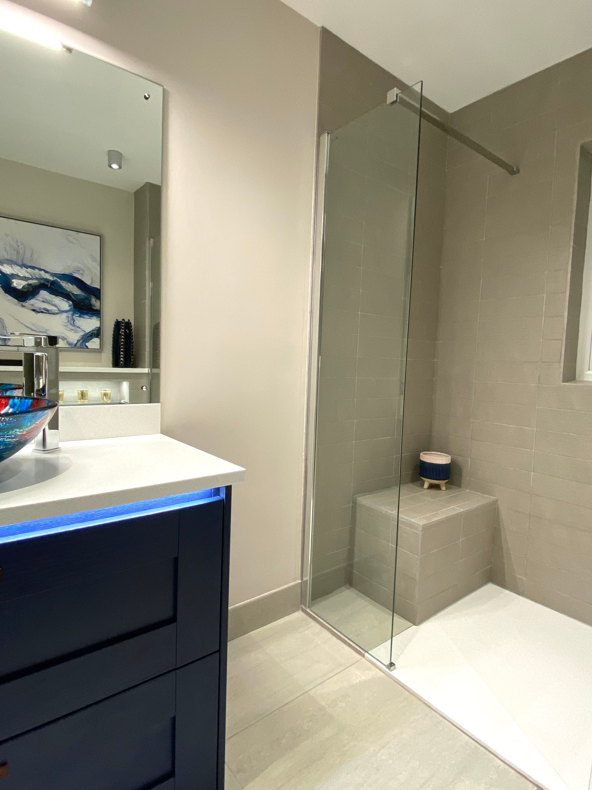 A bathroom with a sink and a walk in shower