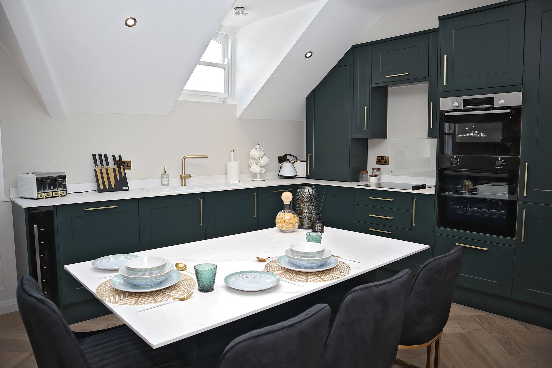 A kitchen with a table and chairs in it