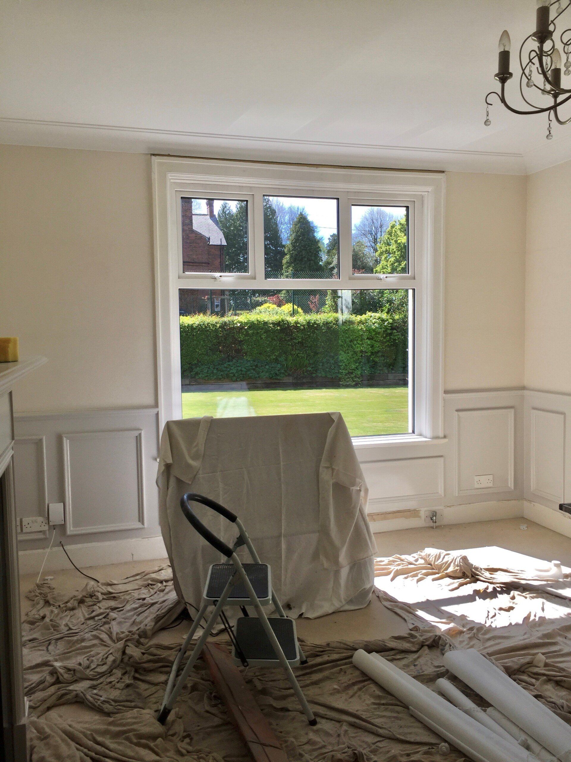 A room with a window and a ladder in it