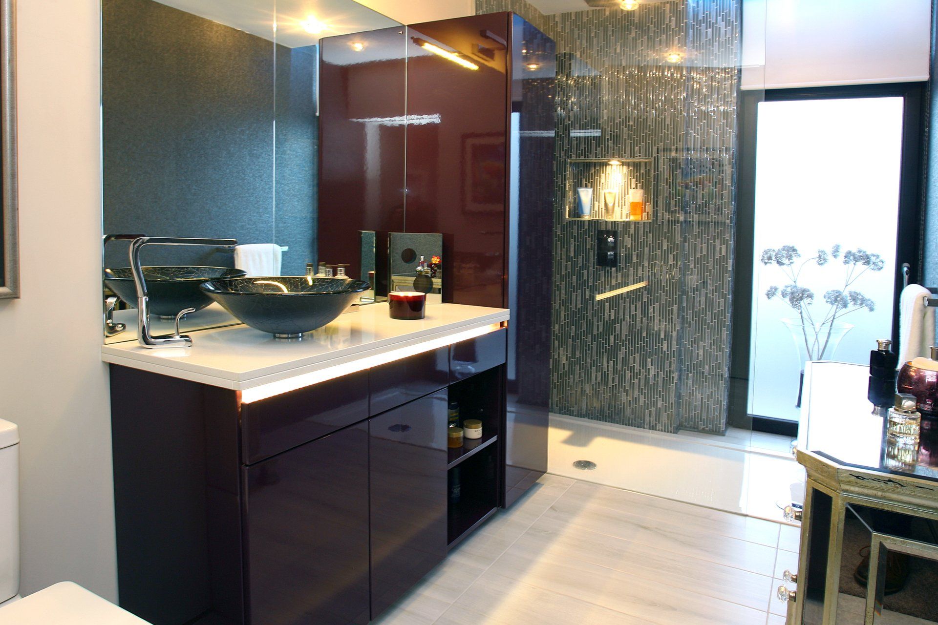 A bathroom with a sink a toilet and a walk in shower