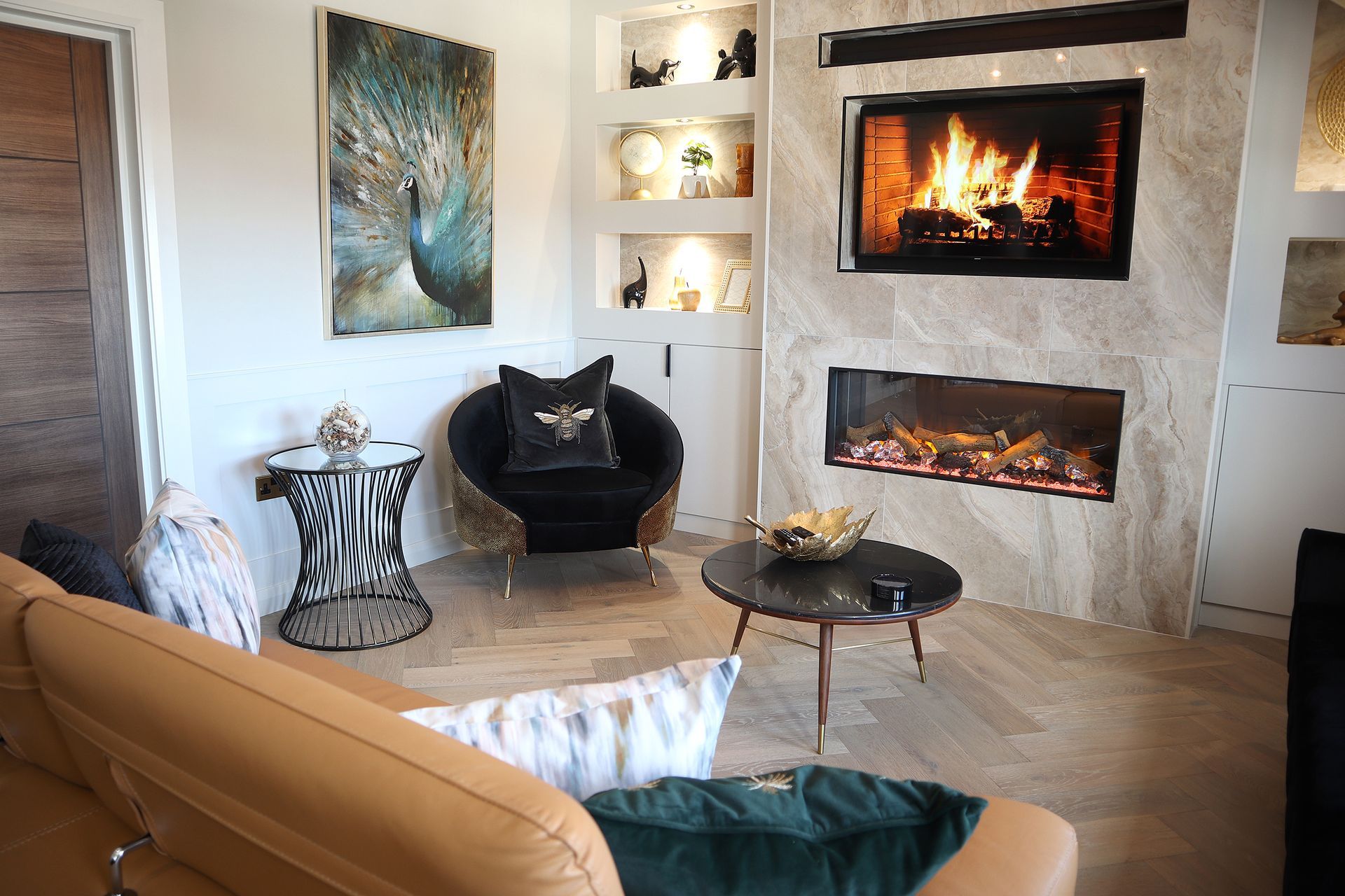 A living room with a couch , chair , table and fireplace.