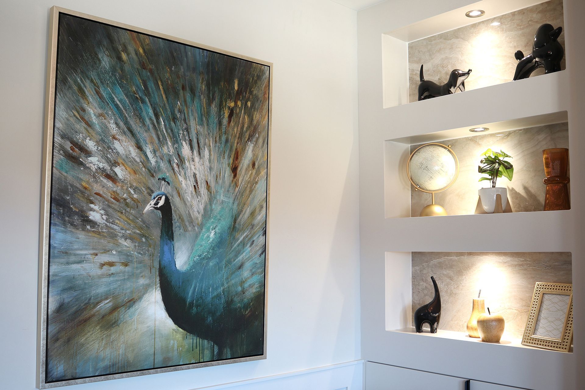 There is a painting of a peacock on the wall.