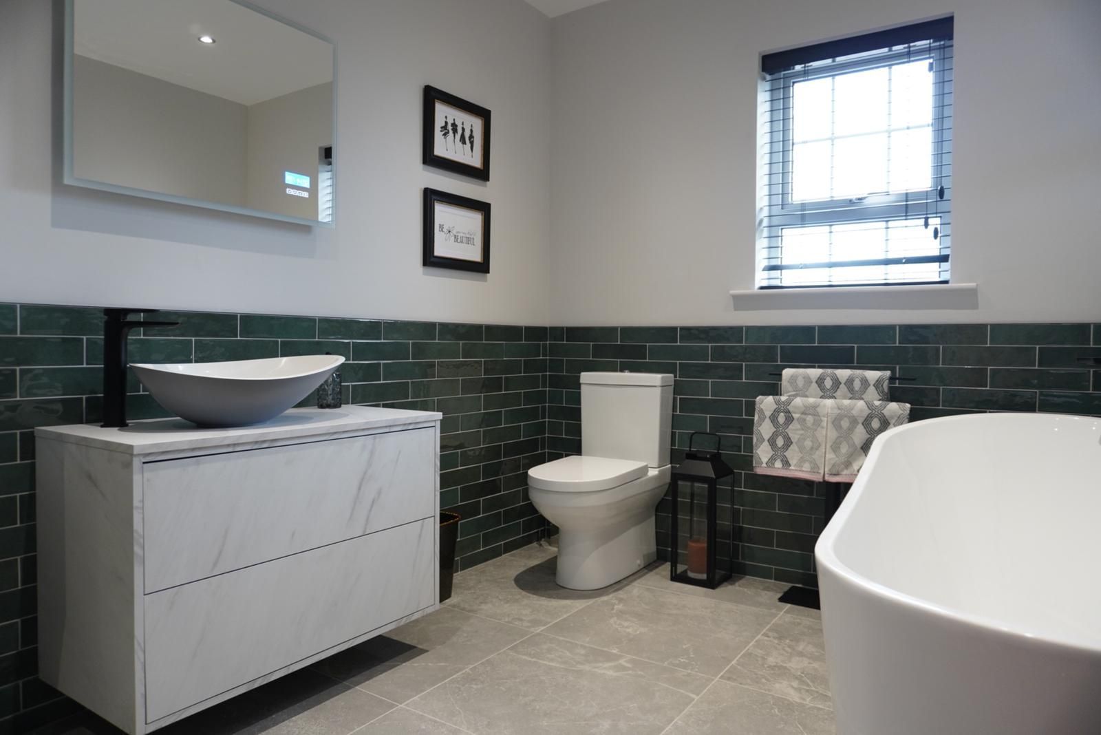 A bathroom with a sink , toilet , and bathtub.