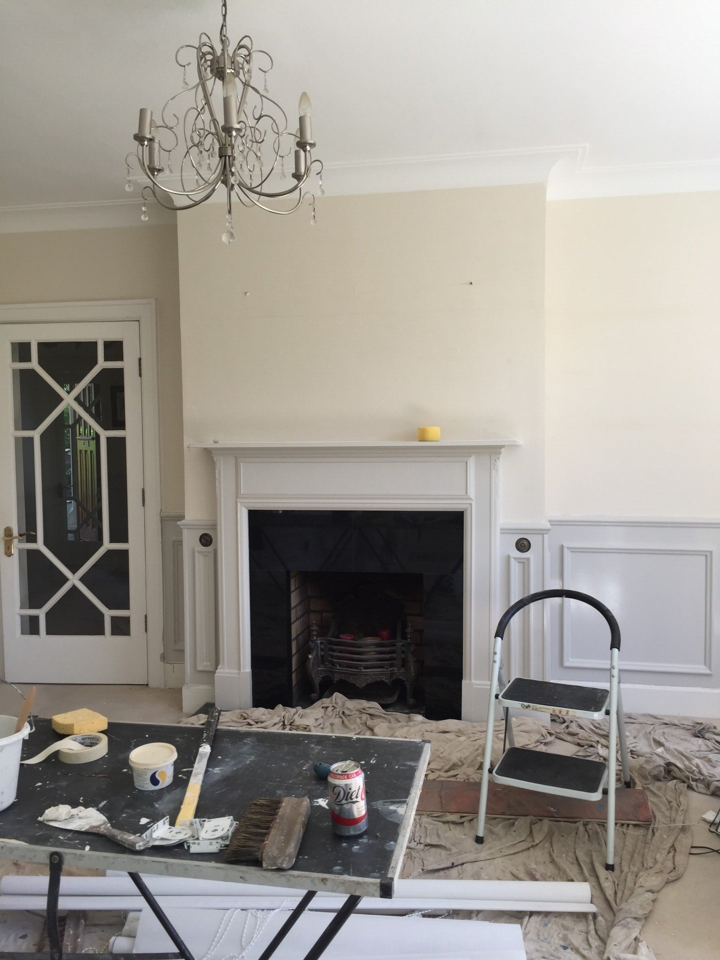 A living room with a fireplace and a table with tools on it.