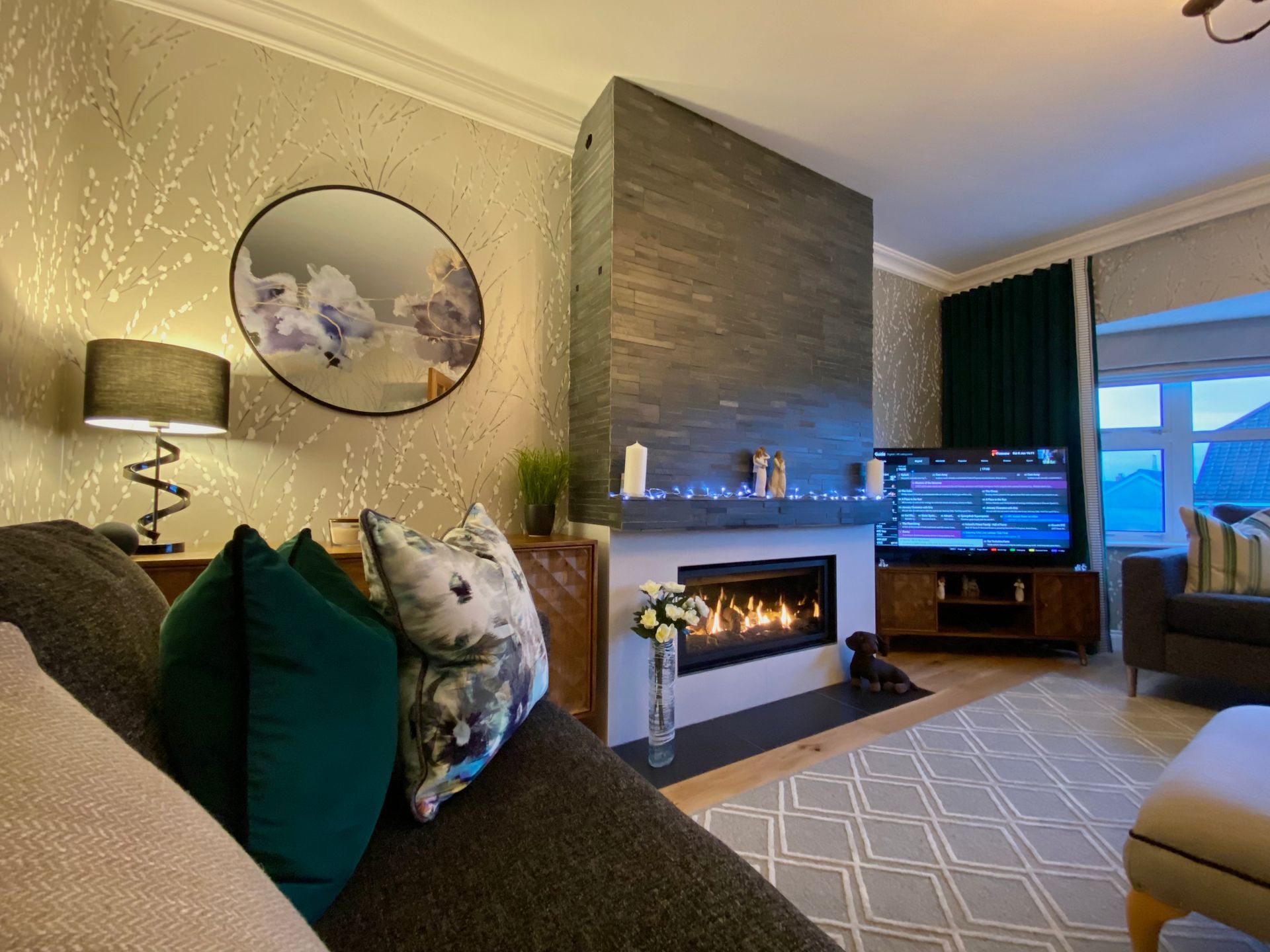 A living room with a fireplace and a flat screen tv.