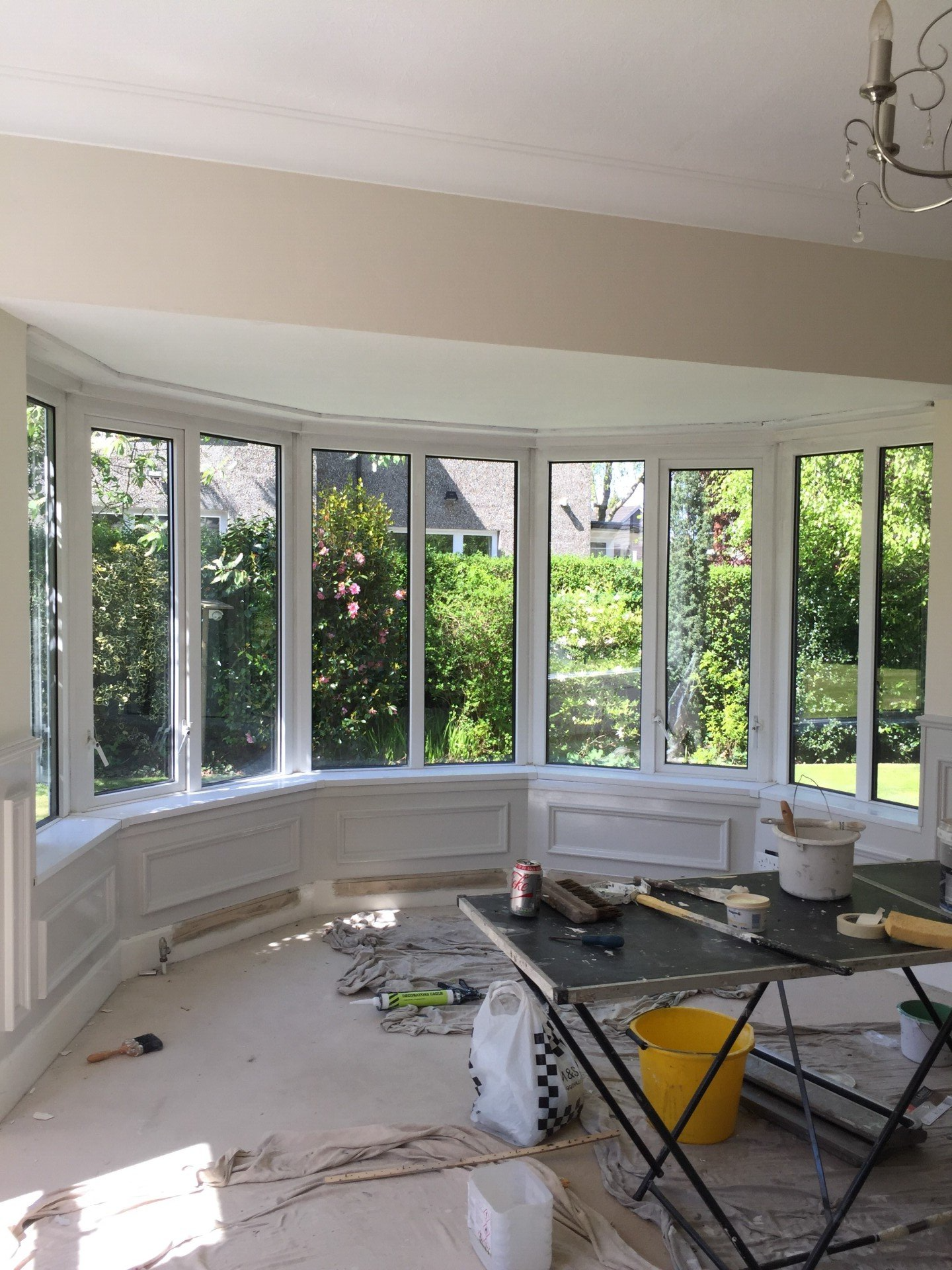 A room with a lot of windows and a table in it.