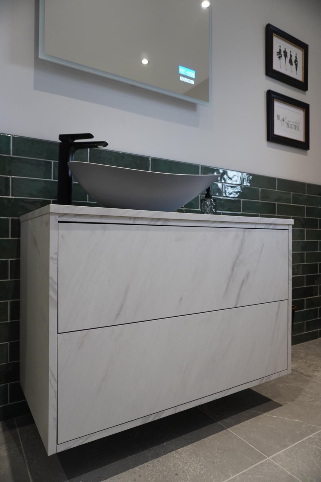 A bathroom vanity with a sink and a mirror.