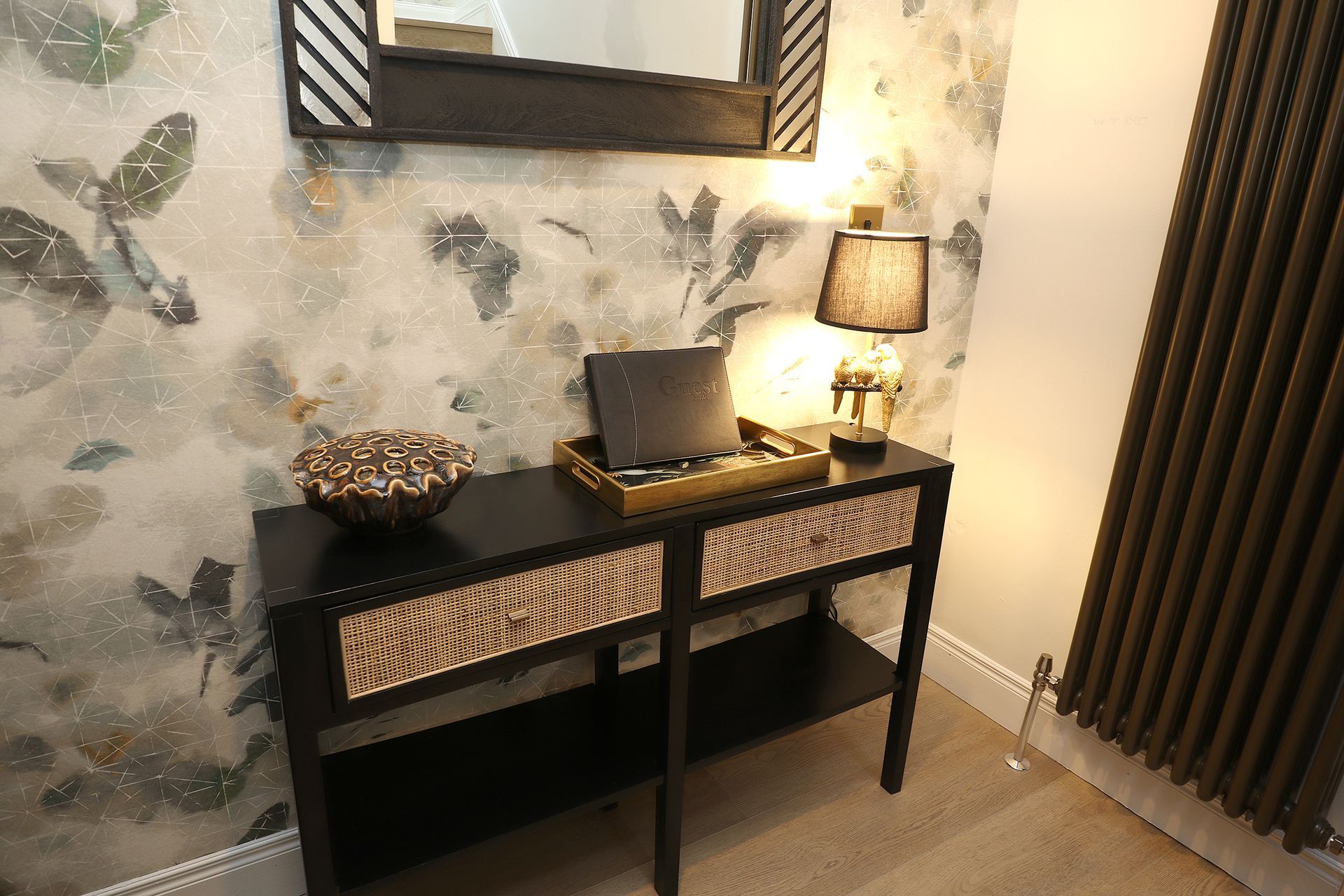 A table with a laptop on it in front of a mirror