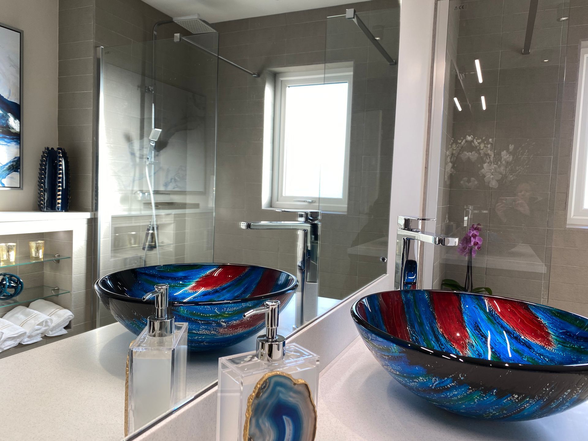 A bathroom with two sinks and a mirror.