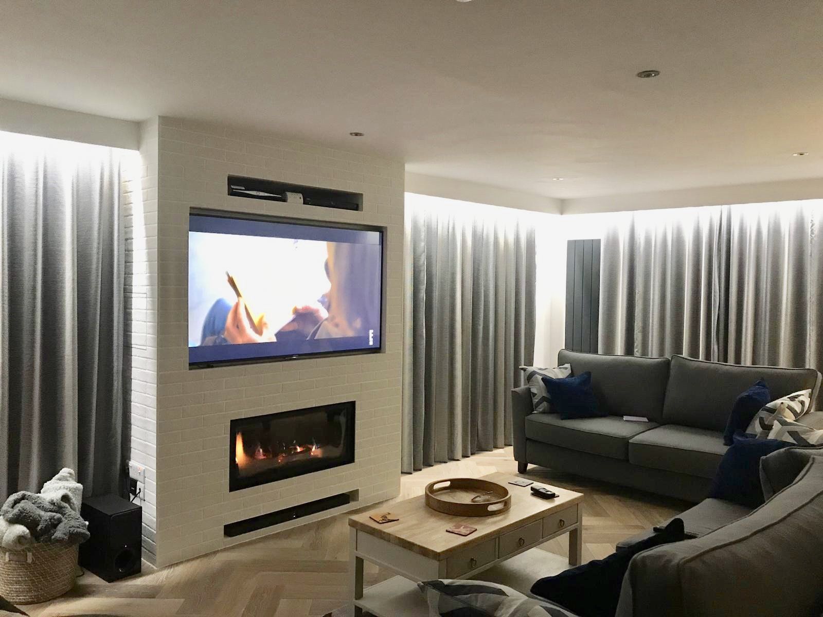 A living room with a fireplace and a flat screen tv.