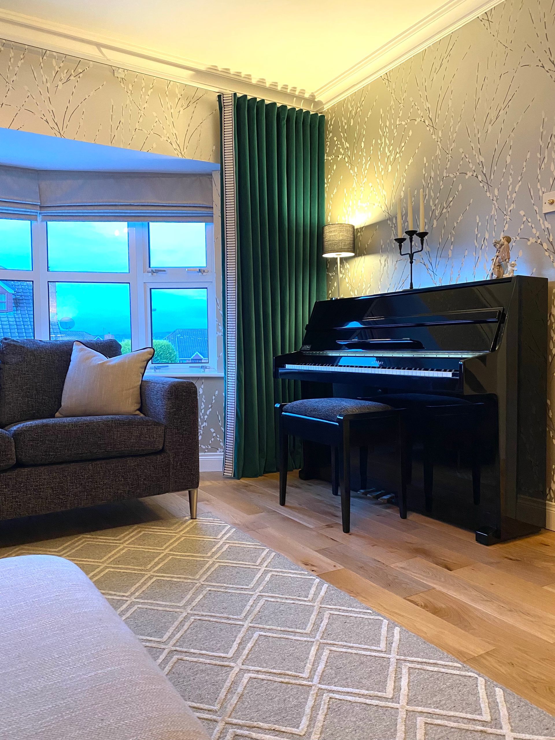 A living room with a piano and a couch.