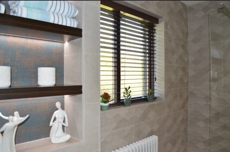 A bathroom with shelves and a window with blinds