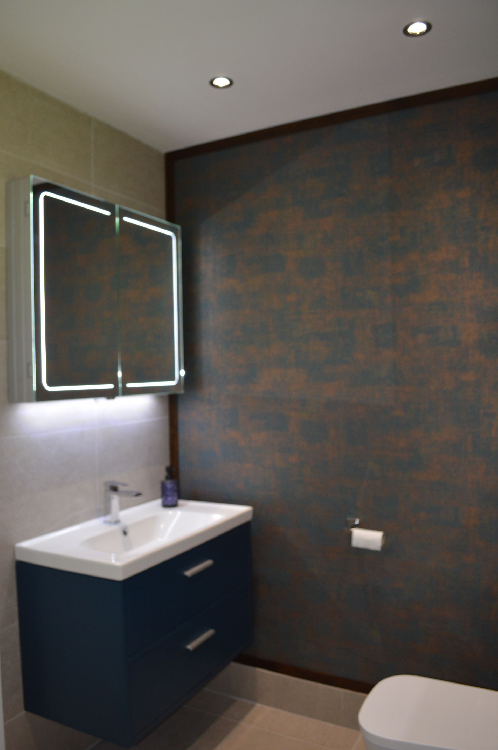 A bathroom with a sink , toilet and mirror