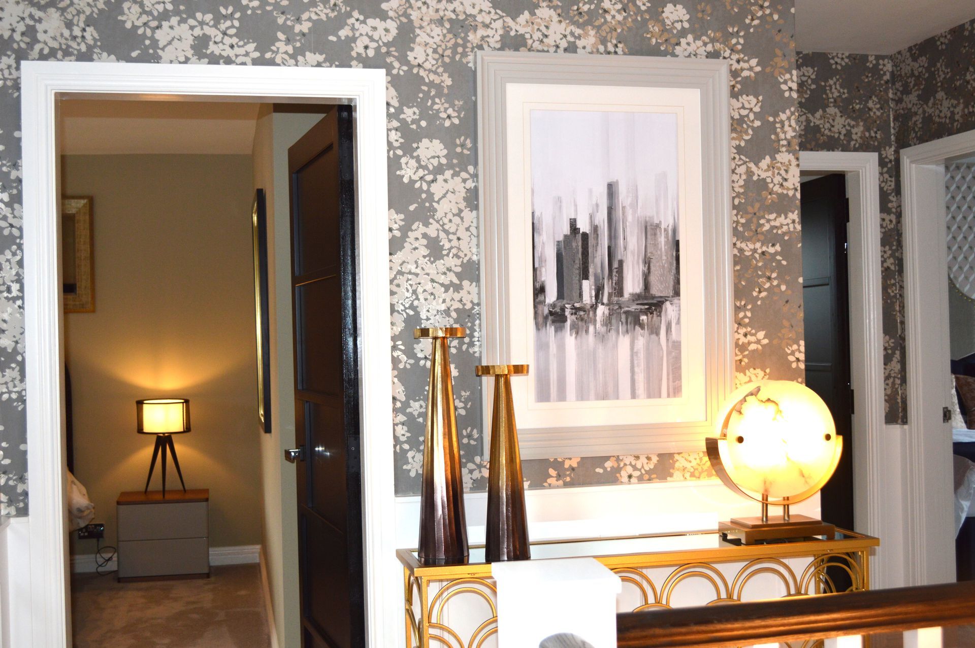 A room with a picture on the wall and a table