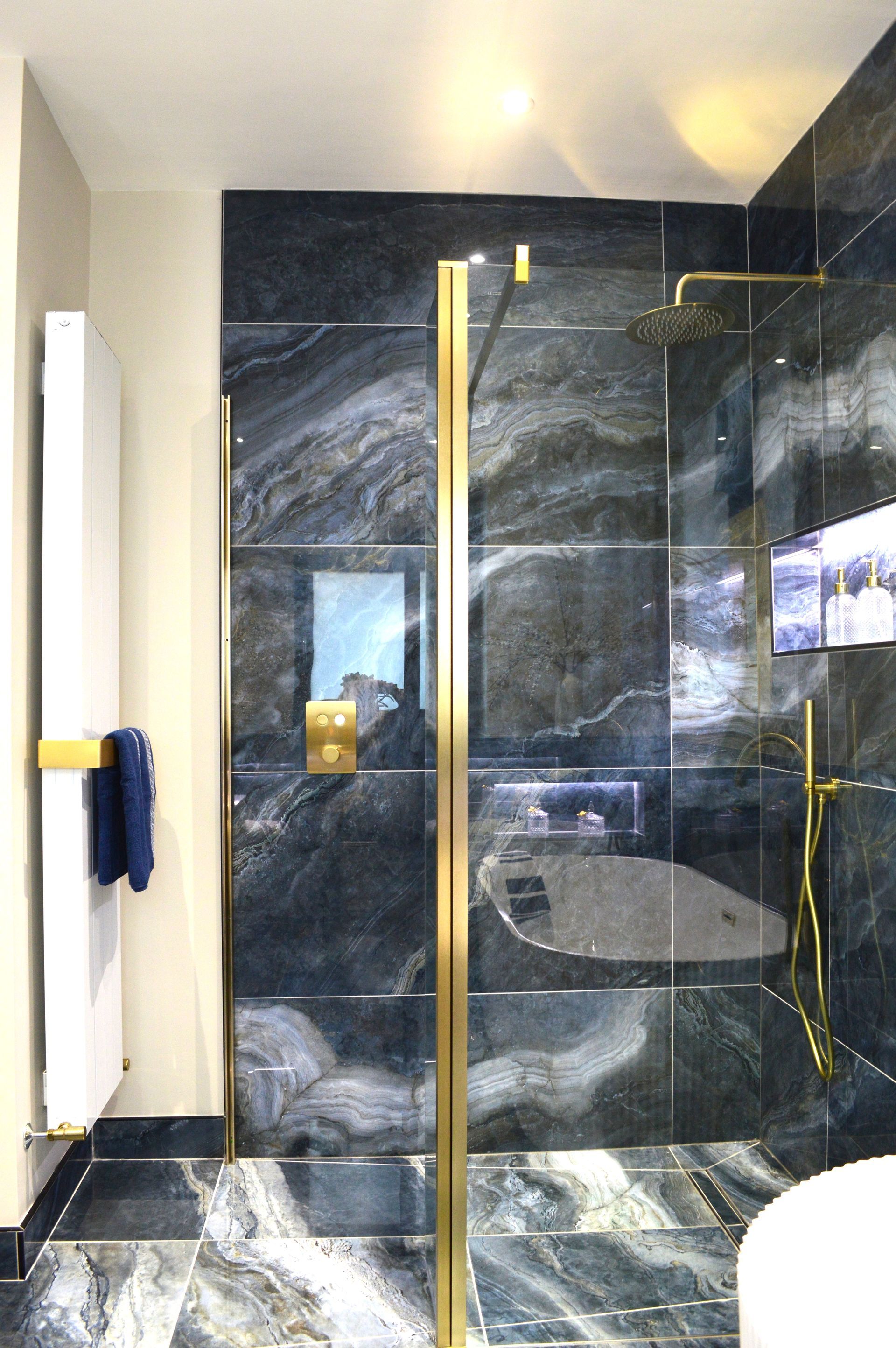 A bathroom with a walk in shower and a toilet.